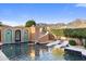 Resort-style pool features a slide, lounge chairs, and views of the mountains at 18127 N 98Th Way, Scottsdale, AZ 85255