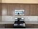 Kitchen showcasing granite countertops, stainless steel appliances and dark wood cabinets at 18162 W Larkspur Dr, Goodyear, AZ 85338
