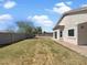 Expansive backyard with a stucco wall, desert landscaping, and patio area ideal for outdoor living at 19707 N Pepka Ct, Maricopa, AZ 85138