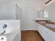 Clean bathroom showcasing double sinks, walk-in shower, and separate tub at 19707 N Pepka Ct, Maricopa, AZ 85138