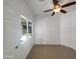 Carpeted bedroom showcasing a ceiling fan and a window providing natural light at 19707 N Pepka Ct, Maricopa, AZ 85138