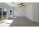 Bright bedroom featuring sliding glass doors, ample natural light and ceiling fan at 19707 N Pepka Ct, Maricopa, AZ 85138