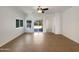 Bright, open living room with tile flooring and sliding glass door access to the backyard at 19707 N Pepka Ct, Maricopa, AZ 85138
