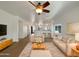 Bright living room features modern decor, a ceiling fan and an open floor plan at 19707 N Pepka Ct, Maricopa, AZ 85138