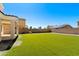 Expansive backyard features pristine artificial turf and a secure brick wall at 2036 E Carob Dr, Chandler, AZ 85286