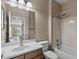 Bathroom featuring vanity with a sink and a mirror with a tub and toilet area in the background at 2036 E Carob Dr, Chandler, AZ 85286