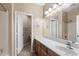 Bathroom featuring vanity with a sink and a mirror with a shower and toilet area in the background at 2036 E Carob Dr, Chandler, AZ 85286