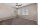 Bedroom featuring carpet, ceiling fan, and natural light coming through the windows at 2036 E Carob Dr, Chandler, AZ 85286