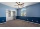 Bedroom featuring a ceiling fan, two-tone paint, carpet, and natural light coming through the window at 2036 E Carob Dr, Chandler, AZ 85286