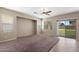 Spacious carpeted bedroom with large windows, sliding glass door access to the backyard at 2036 E Carob Dr, Chandler, AZ 85286