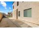 Home exterior with stucco, neutral trim, and a concrete patio leading to the backyard at 2036 E Carob Dr, Chandler, AZ 85286