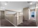 Upstairs hallway with carpet flooring and neutral walls, leading to various rooms at 2036 E Carob Dr, Chandler, AZ 85286