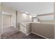 Upstairs hallway featuring neutral decor, carpet, and natural light coming through the windows at 2036 E Carob Dr, Chandler, AZ 85286