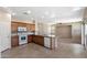 Well-lit kitchen with tile floors, wood cabinets, granite countertops, and white appliances at 2036 E Carob Dr, Chandler, AZ 85286