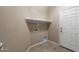 Laundry room with tile flooring, a shelf, and a door at 2036 E Carob Dr, Chandler, AZ 85286