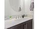 Stylish half-bathroom with a modern vanity, oval mirror, and elegant decor accents at 23386 N 73Rd Way, Scottsdale, AZ 85255
