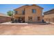 Back view of the house featuring an outdoor patio, grill, and spacious yard at 25218 W Carson Ct, Buckeye, AZ 85326