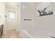 Bathroom featuring a bathtub and a view of the vanity area with a window at 25218 W Carson Ct, Buckeye, AZ 85326