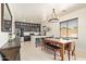 Bright dining area with modern lighting, a spacious dining table, and a view of the kitchen at 25218 W Carson Ct, Buckeye, AZ 85326