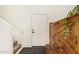 Entryway with a white door, stairs, and a decorative cabinet with a plant at 25218 W Carson Ct, Buckeye, AZ 85326