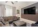Stylish living room with a modern accent wall, comfortable seating, and lots of natural light at 25218 W Carson Ct, Buckeye, AZ 85326
