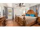 Main bedroom featuring a large bed, a ceiling fan, wood floors, and window with blinds at 25218 W Carson Ct, Buckeye, AZ 85326