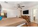 Main bedroom featuring a wooden bed frame, ceiling fan, and closet access at 25218 W Carson Ct, Buckeye, AZ 85326