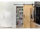 Pantry featuring a barn door and well-organized shelving with various food items and beverages at 25218 W Carson Ct, Buckeye, AZ 85326