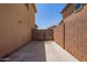 Side yard featuring a privacy gate and block wall at 25218 W Carson Ct, Buckeye, AZ 85326