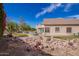 Landscaped backyard boasts rock features, vibrant plants, and serene views at 2602 E Glass Ln, Phoenix, AZ 85042
