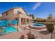 Beautiful backyard featuring a sparkling pool, spa, covered patio, and unique desert mural for stylish outdoor living at 2602 E Glass Ln, Phoenix, AZ 85042