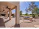 Covered patio leads to a captivating backyard with pool, spa, mature trees and lush greenery, an ideal retreat at 2602 E Glass Ln, Phoenix, AZ 85042