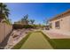 Serene backyard features a rock garden, synthetic turf and low-maintenance landscaping at 2602 E Glass Ln, Phoenix, AZ 85042