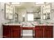 Modern bathroom with double sinks, granite countertops, and a glass-enclosed shower at 2602 E Glass Ln, Phoenix, AZ 85042