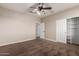 Spacious bedroom features neutral walls, ceiling fan, and an organized closet for ample storage at 2602 E Glass Ln, Phoenix, AZ 85042
