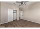Carpeted bedroom featuring a closet with sliding doors and a glimpse of the adjoining room at 2602 E Glass Ln, Phoenix, AZ 85042