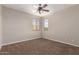 Carpeted bedroom featuring a ceiling fan and a bright window for natural light at 2602 E Glass Ln, Phoenix, AZ 85042