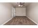 Neutral carpeted bedroom with a ceiling fan and a door leading to other rooms at 2602 E Glass Ln, Phoenix, AZ 85042
