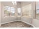 Bright bedroom with natural light streaming through multiple windows with hardwood floors and ceiling fan at 2602 E Glass Ln, Phoenix, AZ 85042