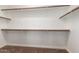 Walk-in closet featuring shelving and bars for ample storage space and organization at 2602 E Glass Ln, Phoenix, AZ 85042