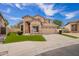 Charming two-story home featuring a red front door, desert landscaping, and a spacious two-car garage at 2602 E Glass Ln, Phoenix, AZ 85042