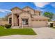 Front exterior showcases desert landscaping and two car garage of this charming tan two-story home at 2602 E Glass Ln, Phoenix, AZ 85042