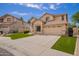 Home exterior with desert landscaping and two car garage, complete with well maintained lawn at 2602 E Glass Ln, Phoenix, AZ 85042