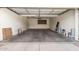 Clean, two-car garage with neutral walls provides ample space for vehicles and storage at 2602 E Glass Ln, Phoenix, AZ 85042