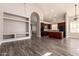 Open-concept kitchen featuring cherry cabinets, granite countertops, stainless steel appliances, and hardwood floors at 2602 E Glass Ln, Phoenix, AZ 85042