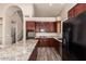 Updated kitchen boasting stainless steel appliances, granite countertops, and cherry wood cabinets at 2602 E Glass Ln, Phoenix, AZ 85042