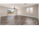 Bright living room features wood-look flooring, sliding glass doors, and a ceiling fan at 2602 E Glass Ln, Phoenix, AZ 85042