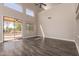 Bright living room with hardwood floors, tall ceilings, and a large sliding glass door to the outside at 2602 E Glass Ln, Phoenix, AZ 85042