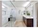 Modern bathroom with white marble walk-in shower featuring a built-in bench and dual sink vanity at 2716 W Sunland Ave, Phoenix, AZ 85041