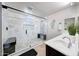 Stylish bathroom with sleek glass shower enclosure, built-in bench, and modern vanity with undermount sink at 2716 W Sunland Ave, Phoenix, AZ 85041